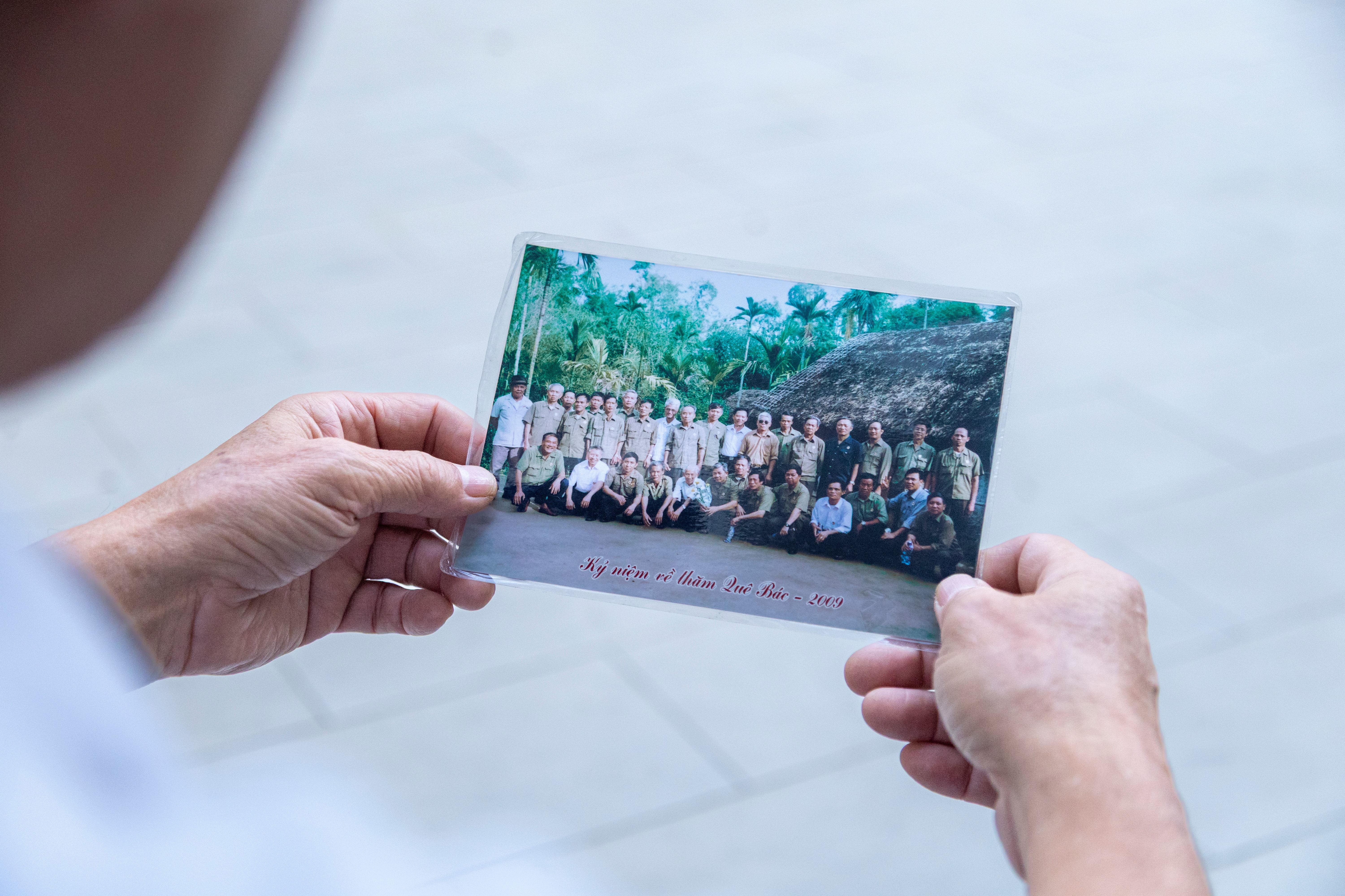 Bức ảnh chụp cùng đồng đội năm 2010 được ông lưu giữ cẩn thận. Theo ông Len, nhiều người trong ảnh đến nay đã không còn. (Ảnh: Trà My)